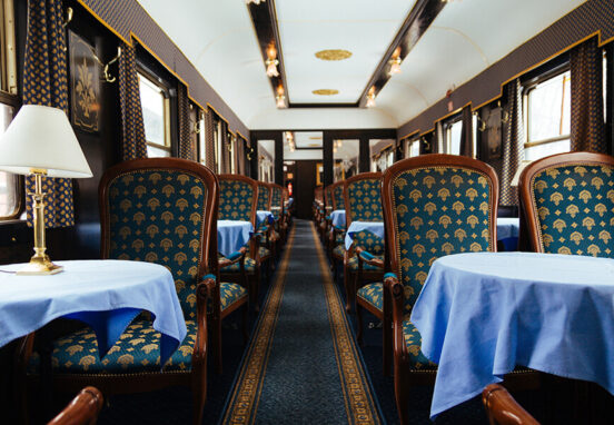 Looking down aisle of dining car on luxury train