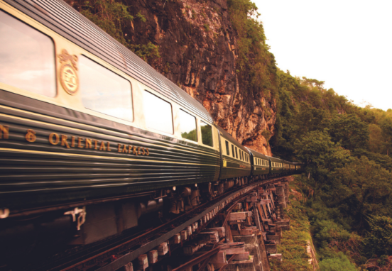 side view of the Eastern & Oriental Express train going around a mountain
